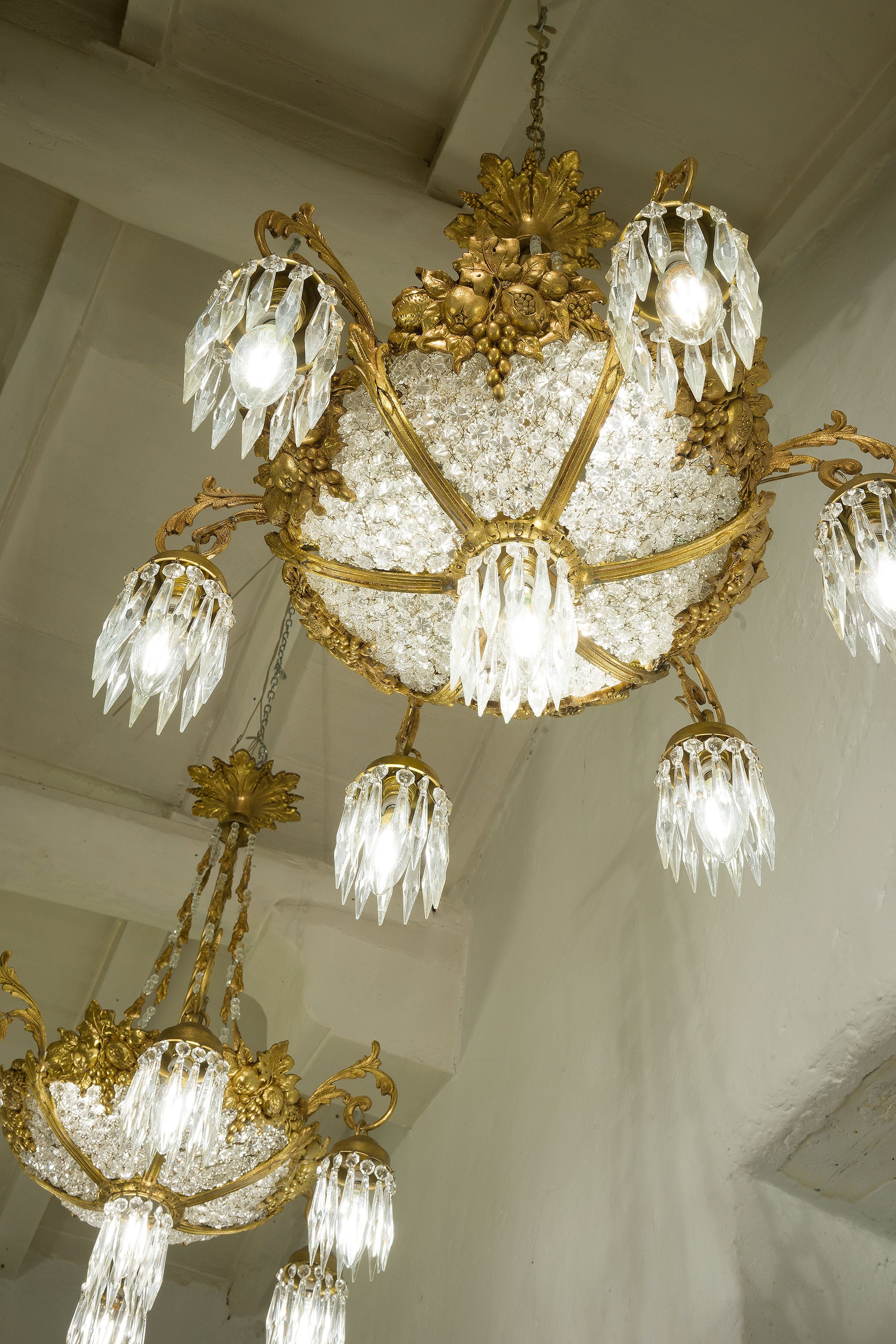 https://www.lostileitaliano.eu/cdn/shop/products/Pair-of-Old-Empire-Style-Chandeliers-in-Brass-and-Crystal.jpg?v=1696967944&width=1946
